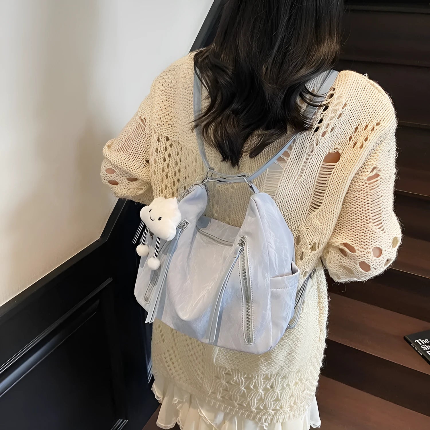 Women's soft black PU fashion backpack with adjustable straps and a silver pendant.