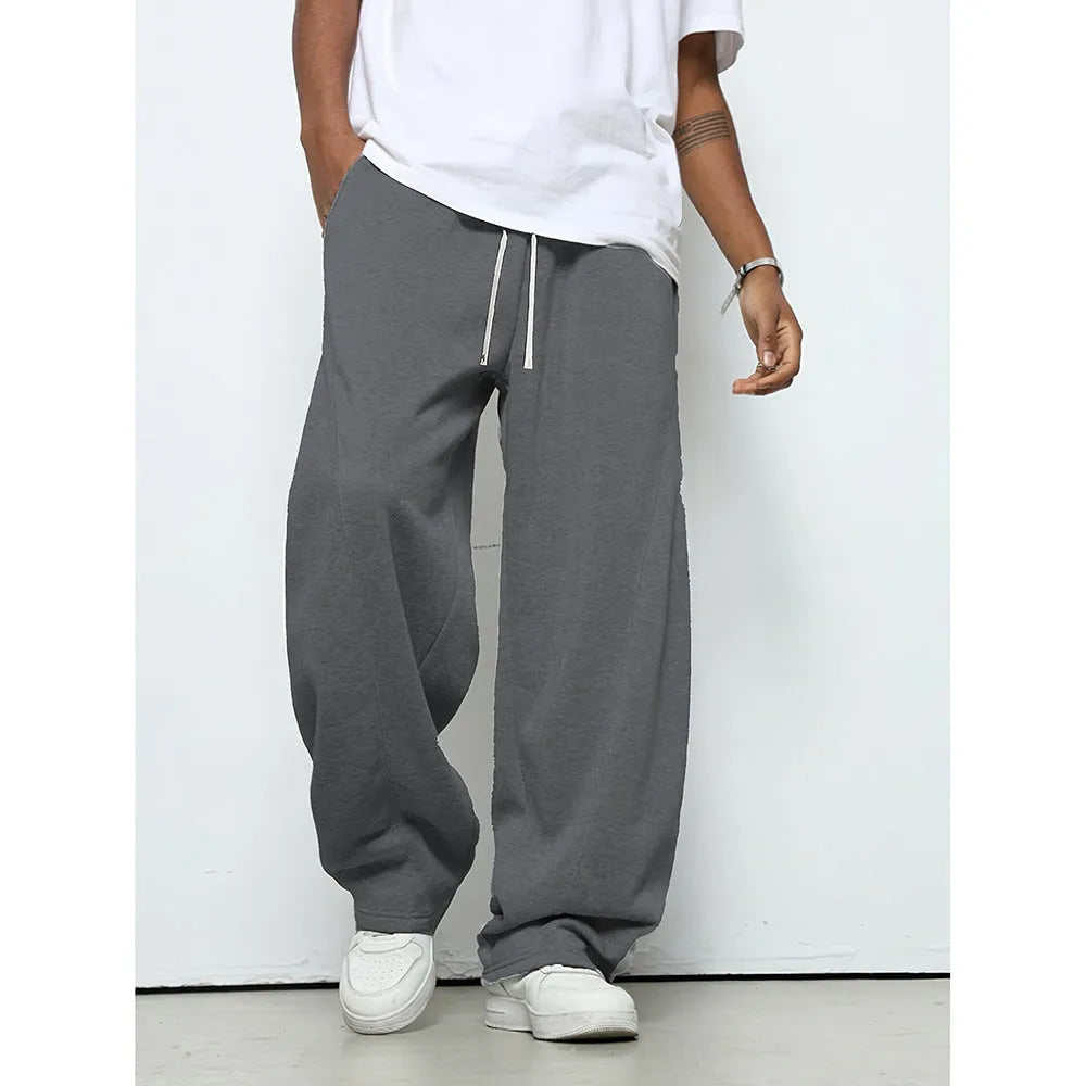 Man wearing solid-colour straight-leg polyester casual trousers with a drawstring waist.