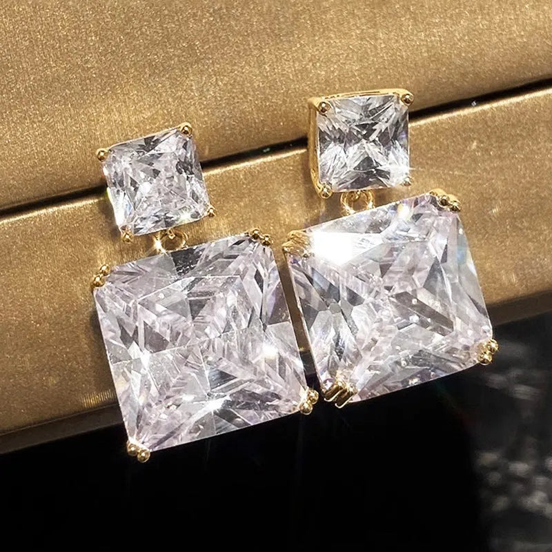 A pair of copper geometric square earrings with a quadrilateral design in a gold colour finish.