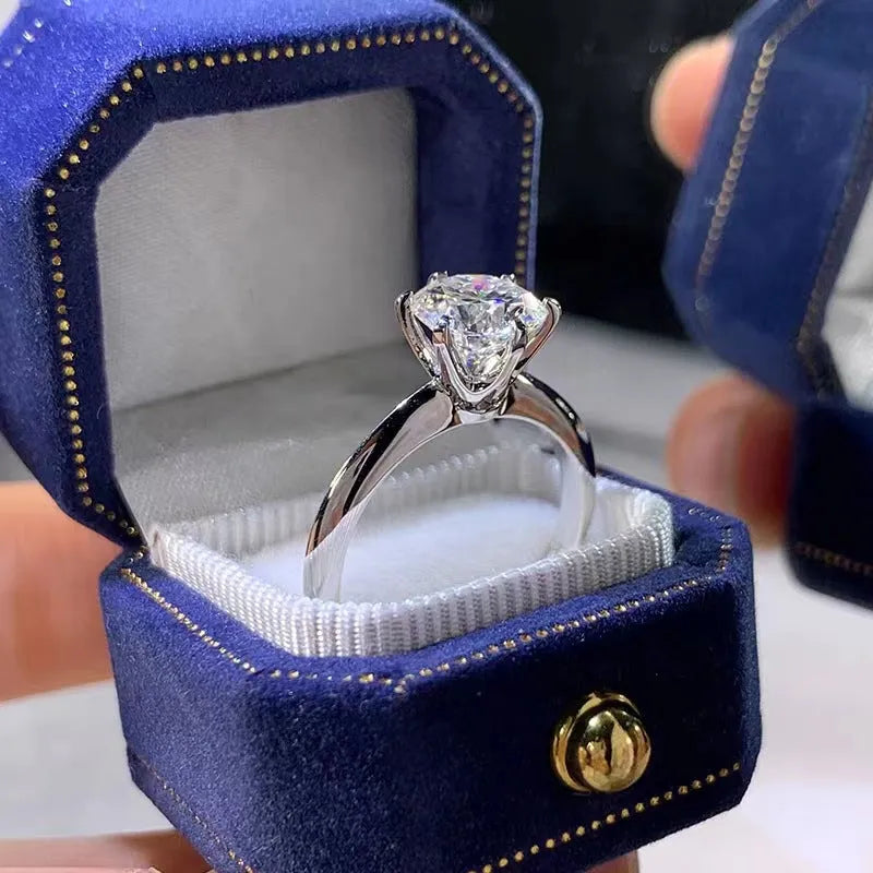 White gold plated geometric ring with a six-claw setting holding a zircon stone.