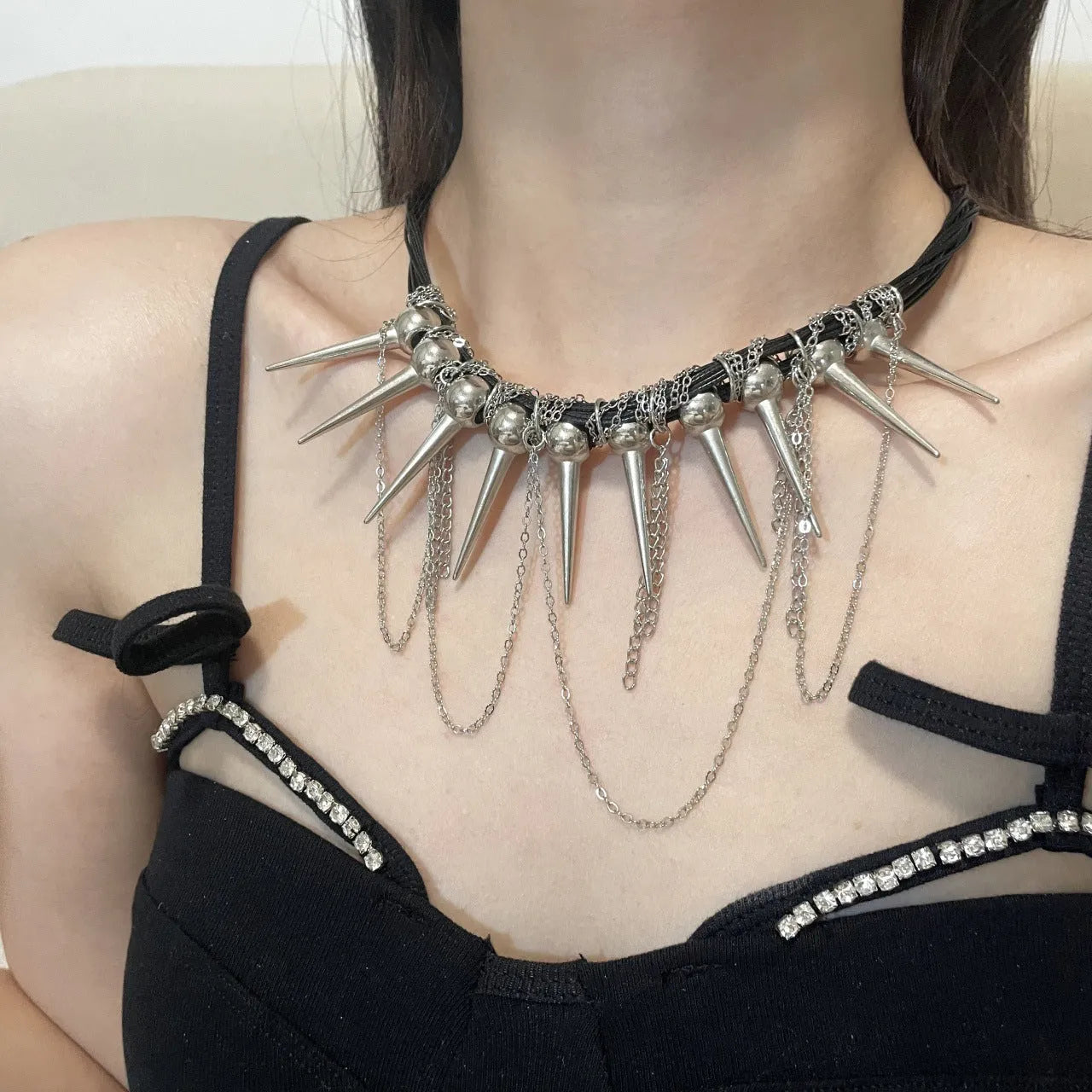 Leather necklace with winding tassel, round beads and point rivet details in electroplated picture colour
