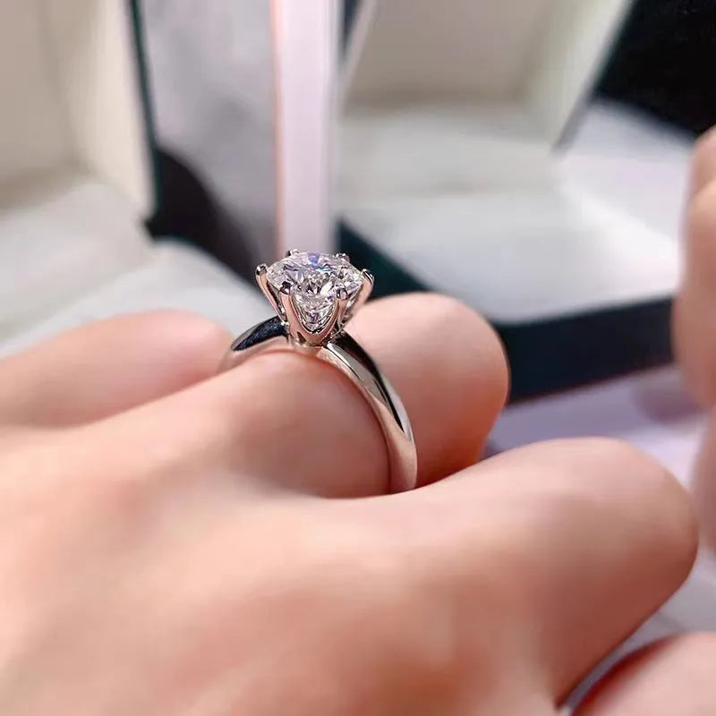 White gold plated geometric ring with a six-claw setting holding a zircon stone.