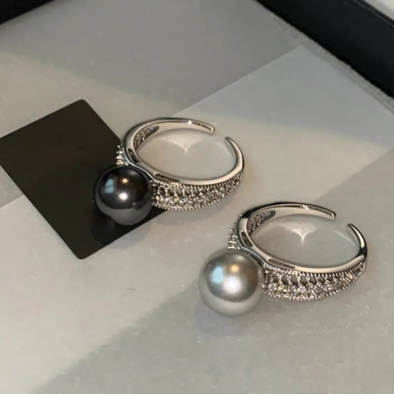 Copper geometric adjustable ring with black pearl finish on feminine hand