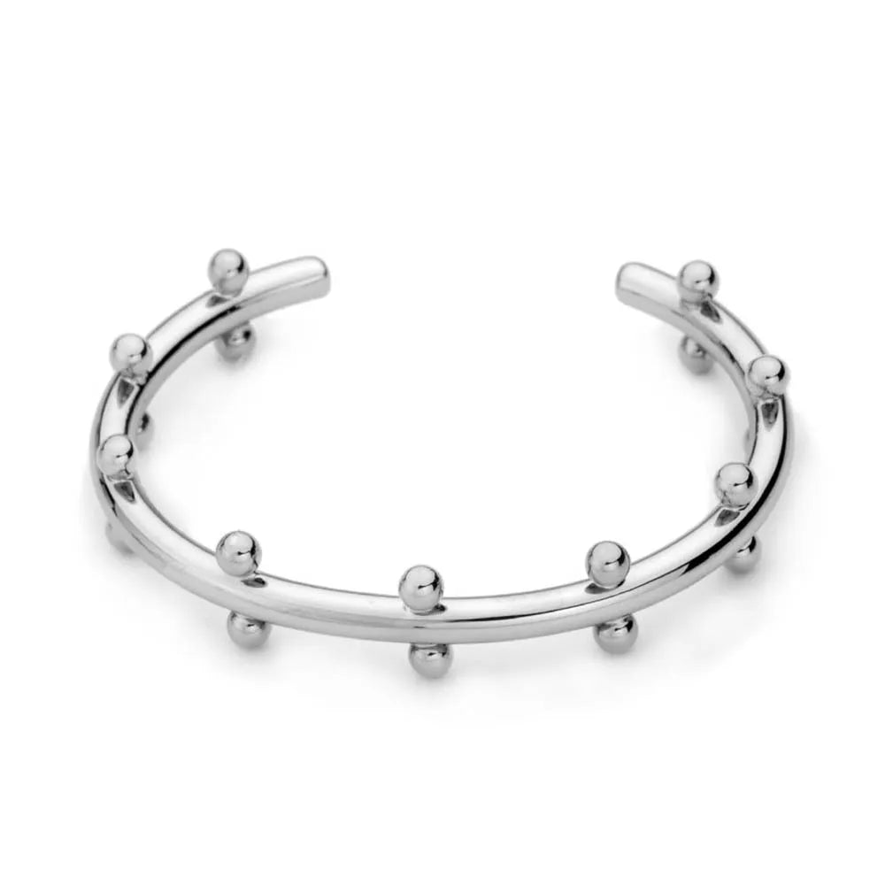 Stainless steel bracelet with C-shaped bean bead charm featuring texture and rivet details.