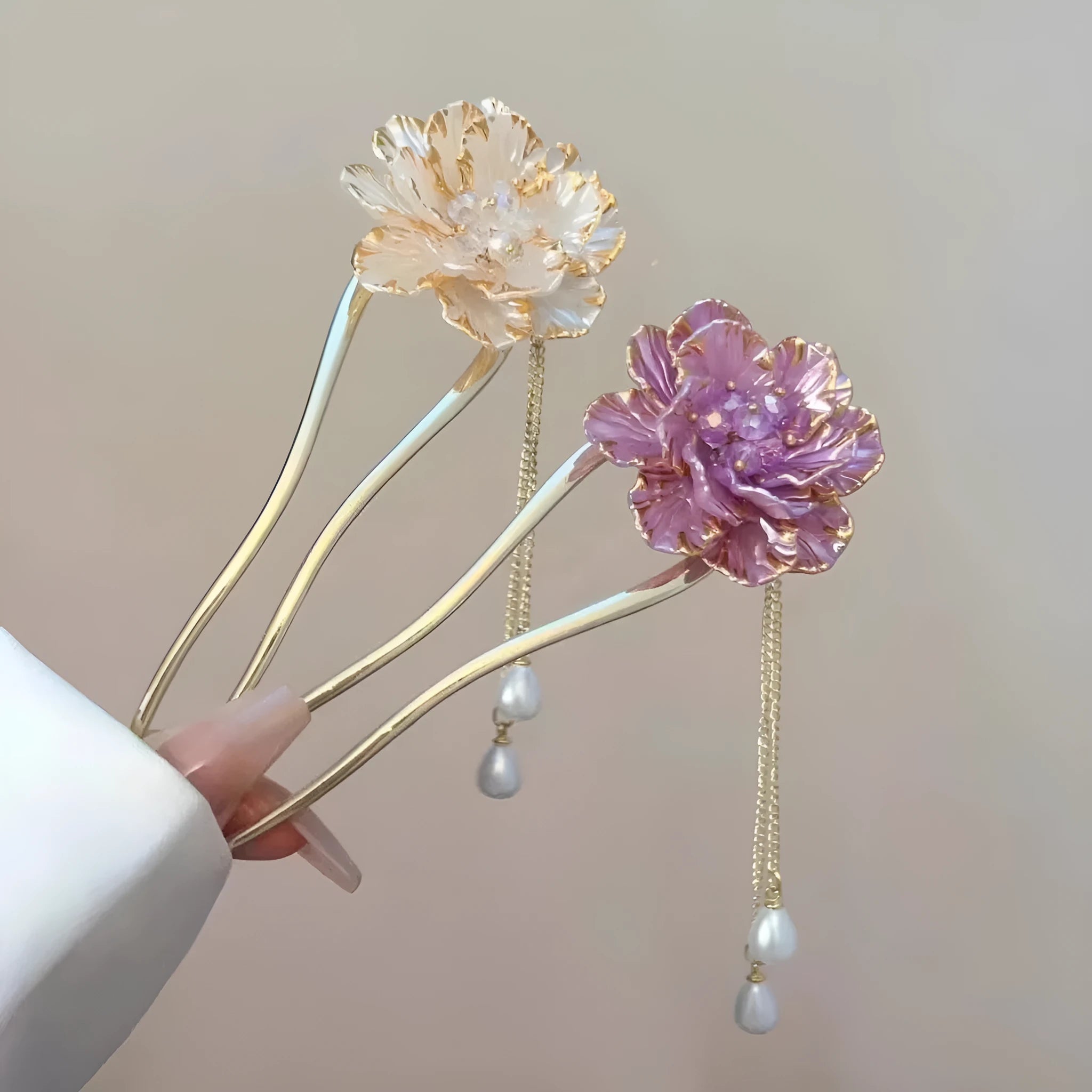 Close-up of a retro-style U-shaped alloy hairpin with a detailed peony flower and tassel design, shown in a purple electroplated finish.