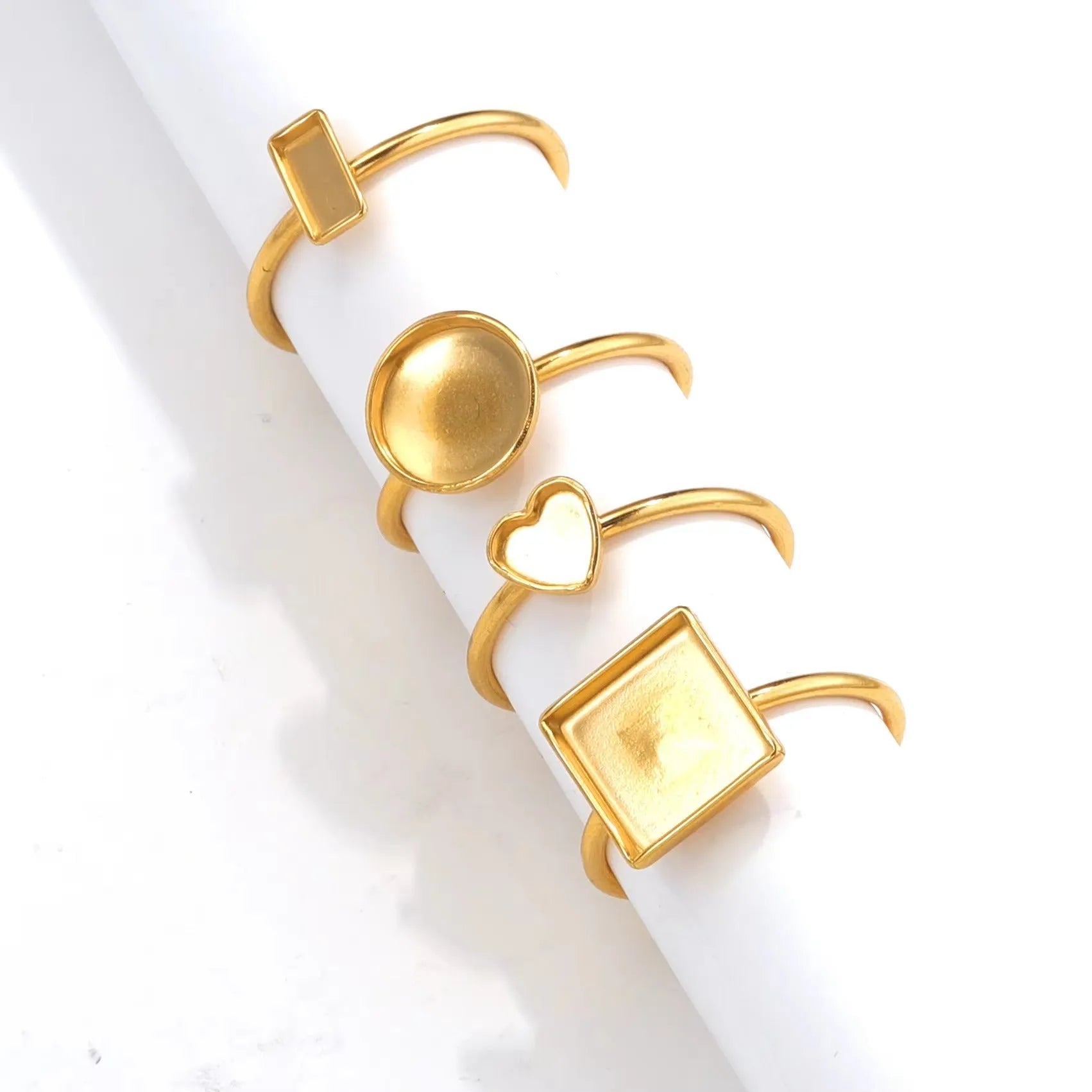 Golden electroplated stainless steel ring settings in various shapes with totem pattern texture and ring holder