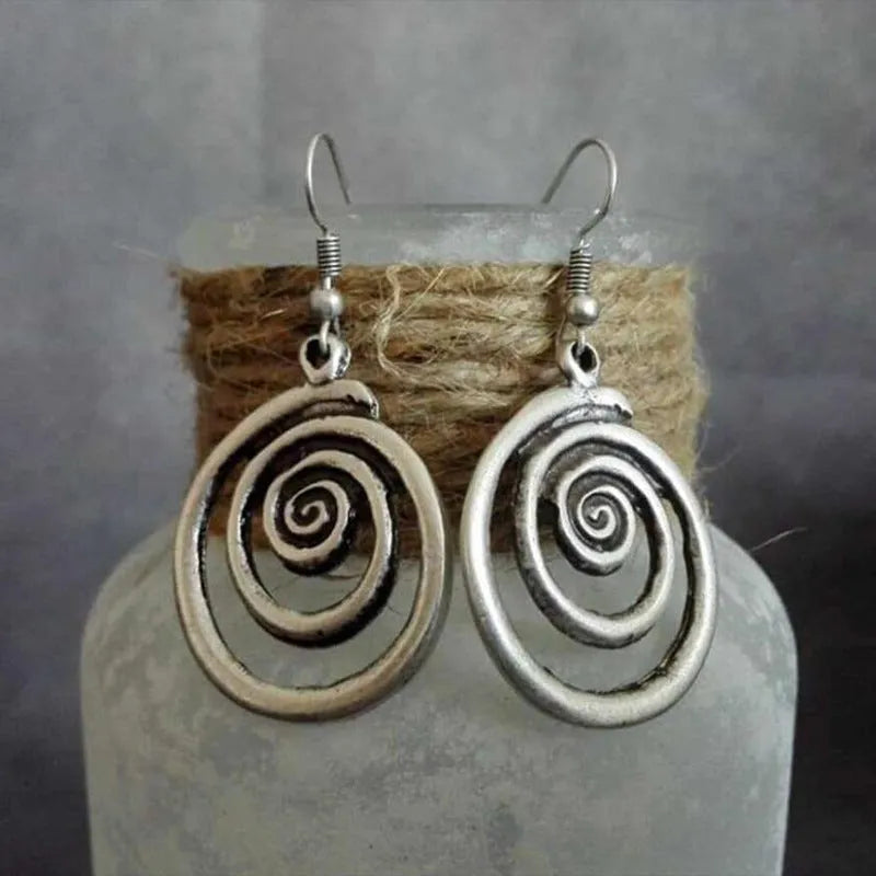Silver geometric spiral earrings with distressed finish measuring 2.6 by 5 centimetres