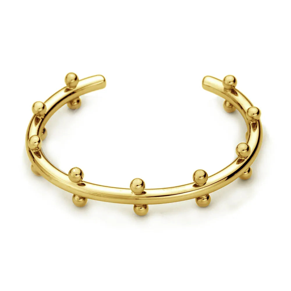 Stainless steel bracelet with C-shaped bean bead charm featuring texture and rivet details.