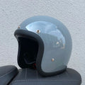 FRP retro-style half motorcycle helmet shown in a cement grey colour variant.