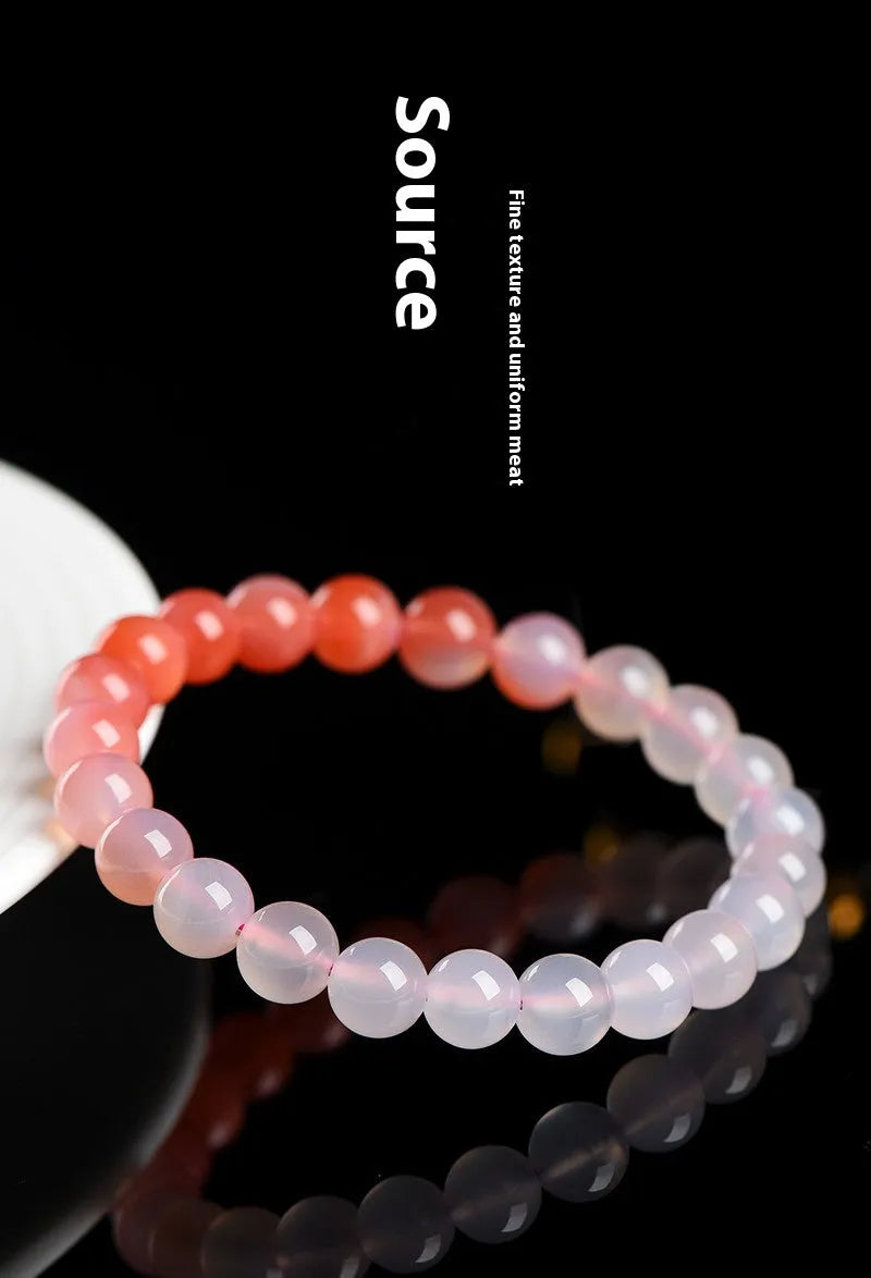 Natural gradient Yanyuan agate bracelet with geometric beads in salt source colour on a wrist.