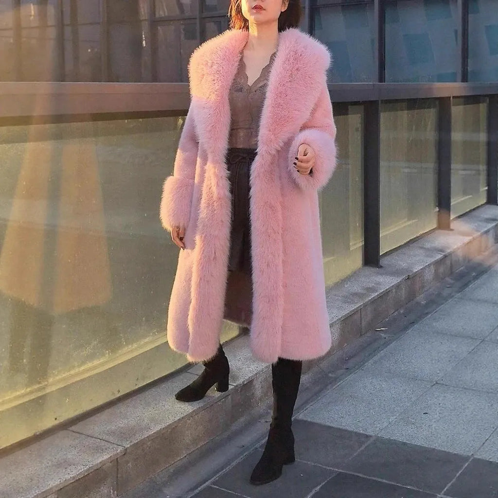 Woman wearing a grey mid-length faux rabbit fur coat with a matching fur collar.