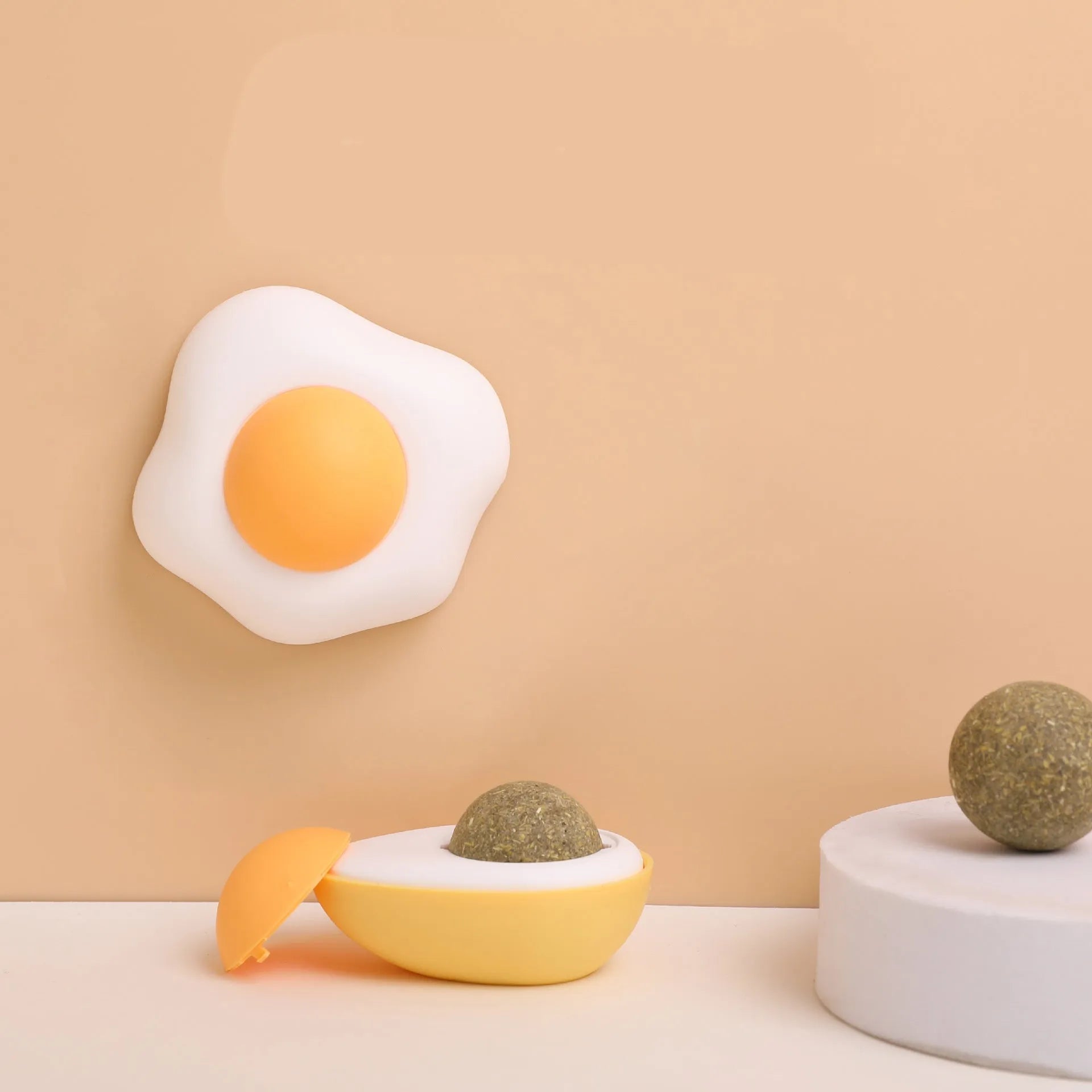 Organic catnip ball toy in fried egg and poached egg designs with wall mount capability