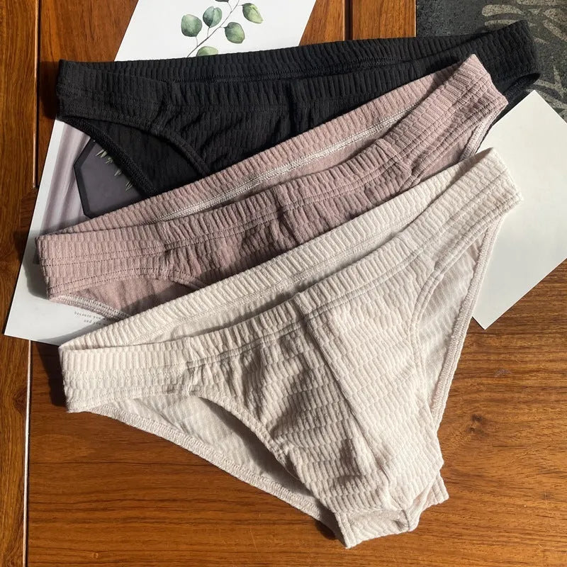 Men's solid colour cotton briefs with a mid waist and triangle design.