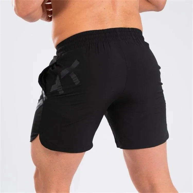 Men's black elastic training shorts with a knee-length cut on a plain background.