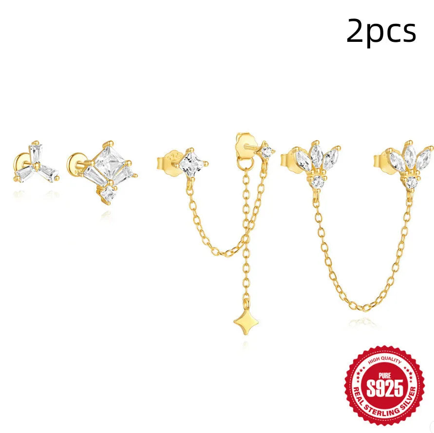 S925 sterling silver stud earrings with zircon inlay in golden geometric designs including clover and crown.