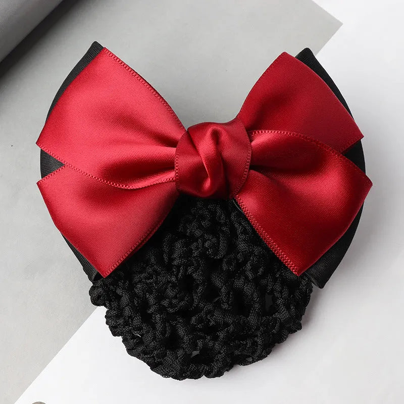 Professional flower bow headdress hair clip ornament on a work plate, shown in a selection of net and mesh colour variations.