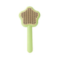 Green self-cleaning cat comb with stainless steel needle pins on a white background