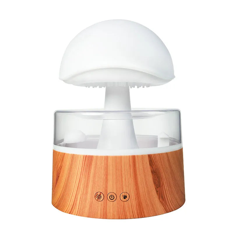 White cloud-shaped humidifier and aroma diffuser with LED lights and mist output on a wooden table.