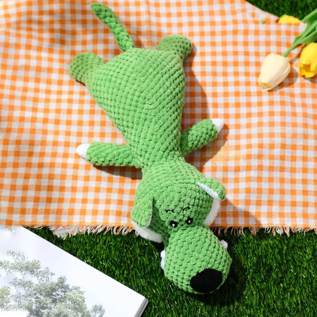 Four plush dog chew toys in green, grey and yellow with corn kernel texture design