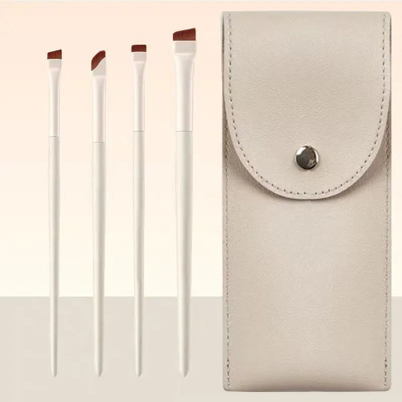 Four angled eyeliner and brow brushes with fine tips in leather case for precise makeup application