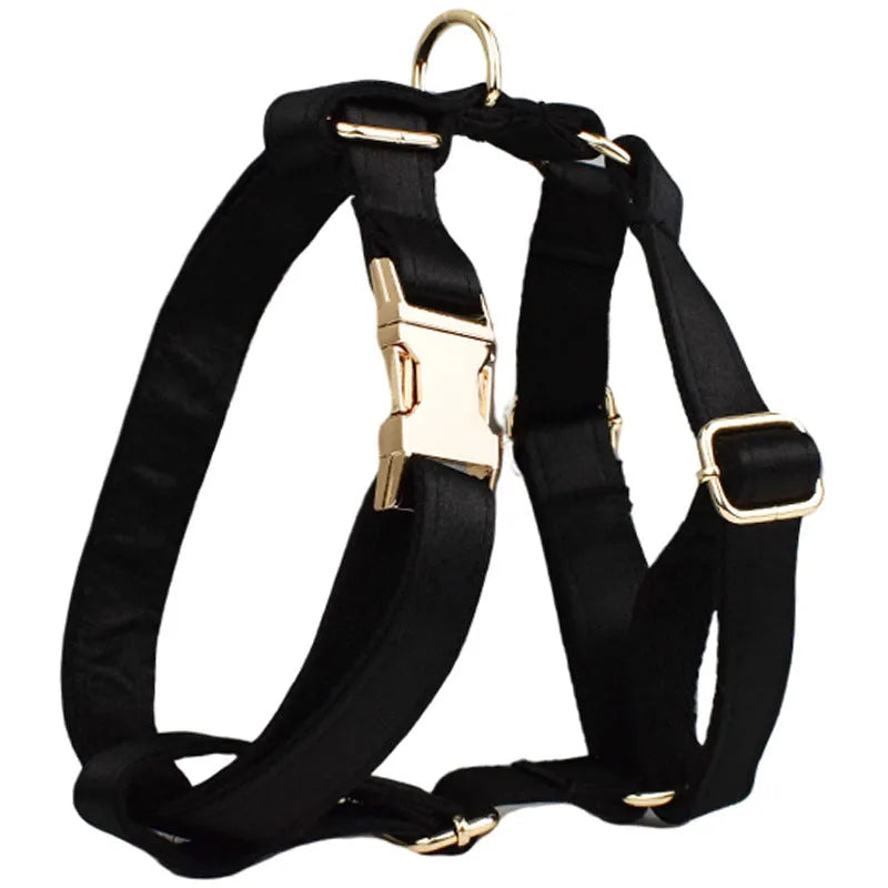 A soft cloth dog collar, leash, bow, and matching chest strap set laid out flat, showing coordinated colours.