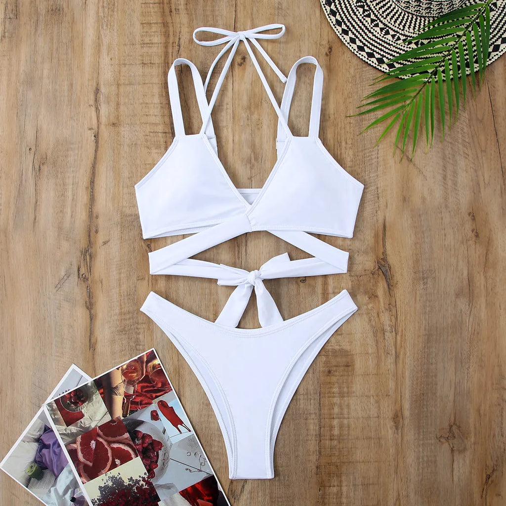 Women's solid colour strap beach bikini swimsuit in a briefs style, shown in one of five colour options.