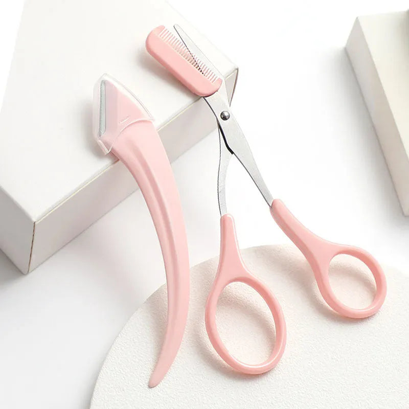 Close-up of a white and pink eyebrow trimming knife with a small curved plastic comb on a plain background.