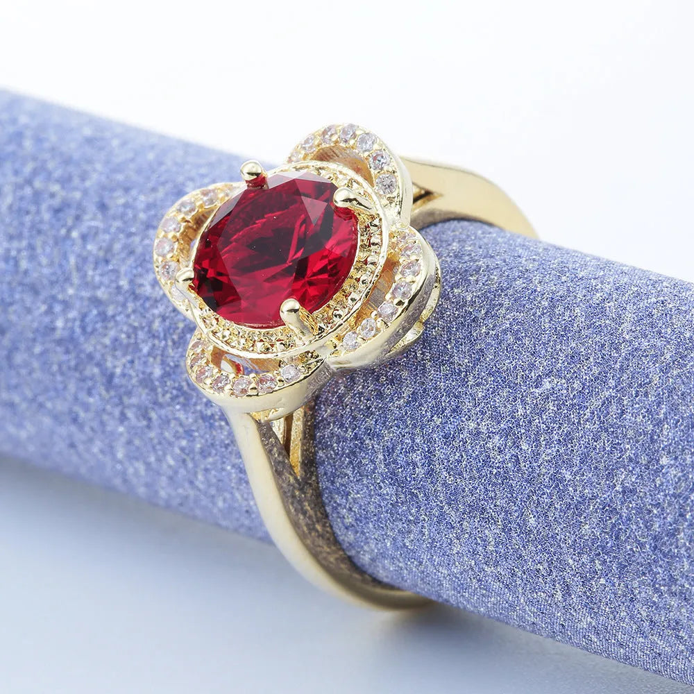 Copper fruit-shaped ring with zircon inlay in electroplated 10-6-1395 colour on a finger.