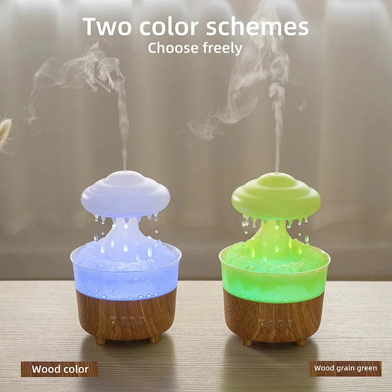 Wood grain green rain cloud shaped humidifier diffuser with coloured LED light on a table.