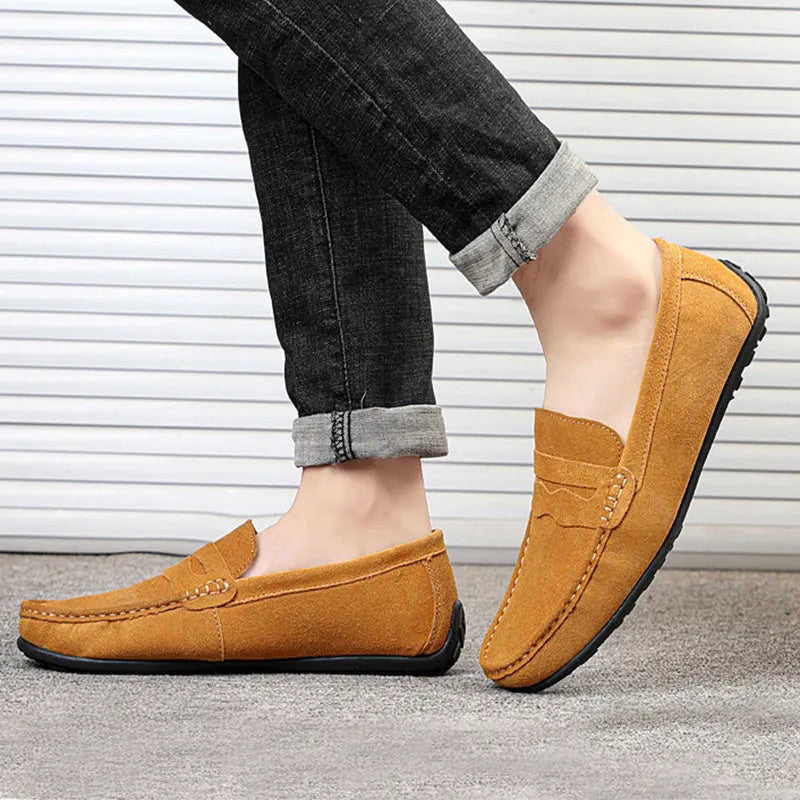 Men's suede slip-on loafers in a solid colour with a round toe and flat rubber sole.