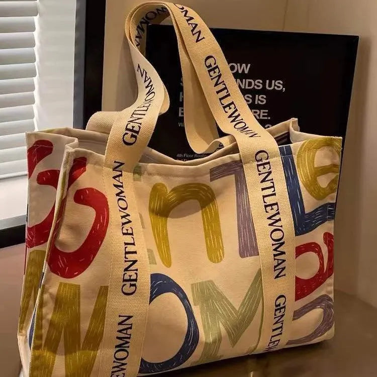 Canvas women's tote bag with printed letter or pattern designs and shoulder straps