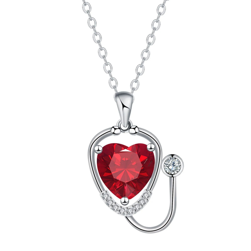 Red diamond coloured women's necklace with wings, cross, and stethoscope pendant.