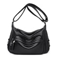 Large black PU shoulder bag with crossbody strap showing multiple internal compartments and zipper closure