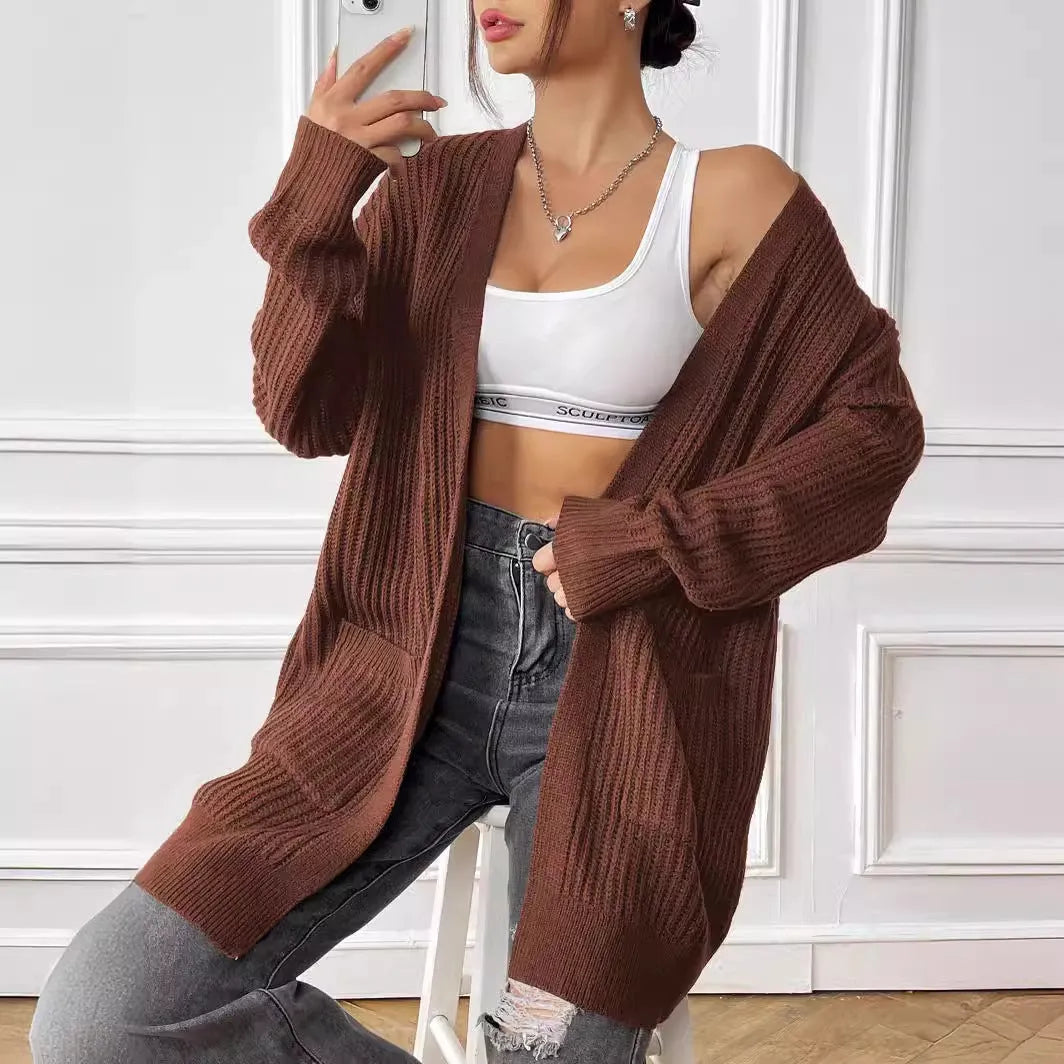 Women's loose acrylic cardigan with two pockets in dark green colour, mid-length design