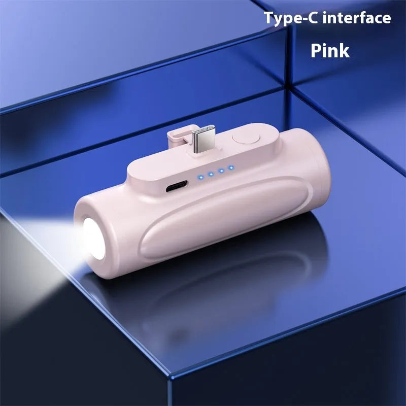 Black and pink creative power bank with integrated LED flashlight, showing Type-C and Apple port options, 83mm long.