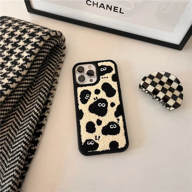 Black plush soft back phone case featuring a fairy character design for compatible iPhone models.