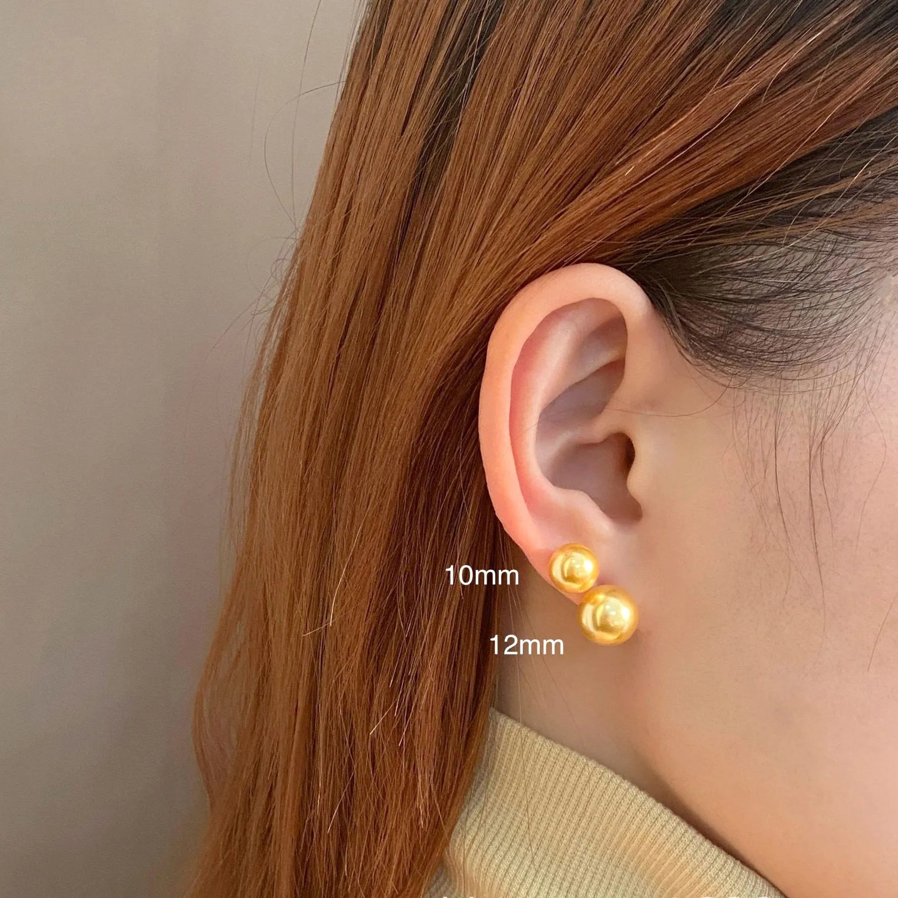 A pair of large geometric pearl stud earrings with an eight-point star detail on silver settings.