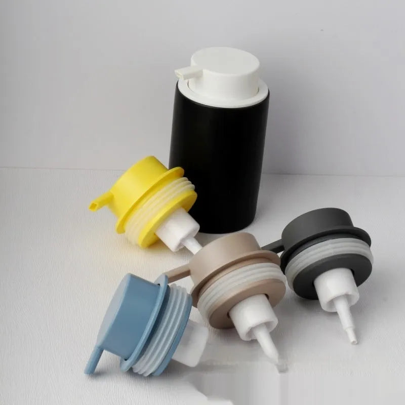 ABS plastic foam pump dispenser with large metallic push head in matte black finish.