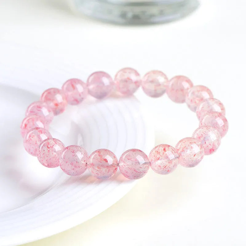 Natural white water strawberry quartz crystal bead bracelet with spherical 10mm beads on elastic.