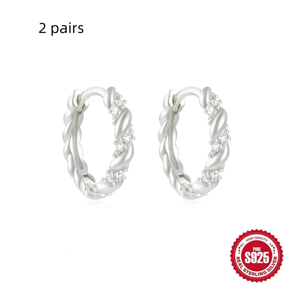 Sterling silver geometric stud earrings with small round designs in gold or silver electroplated finishes
