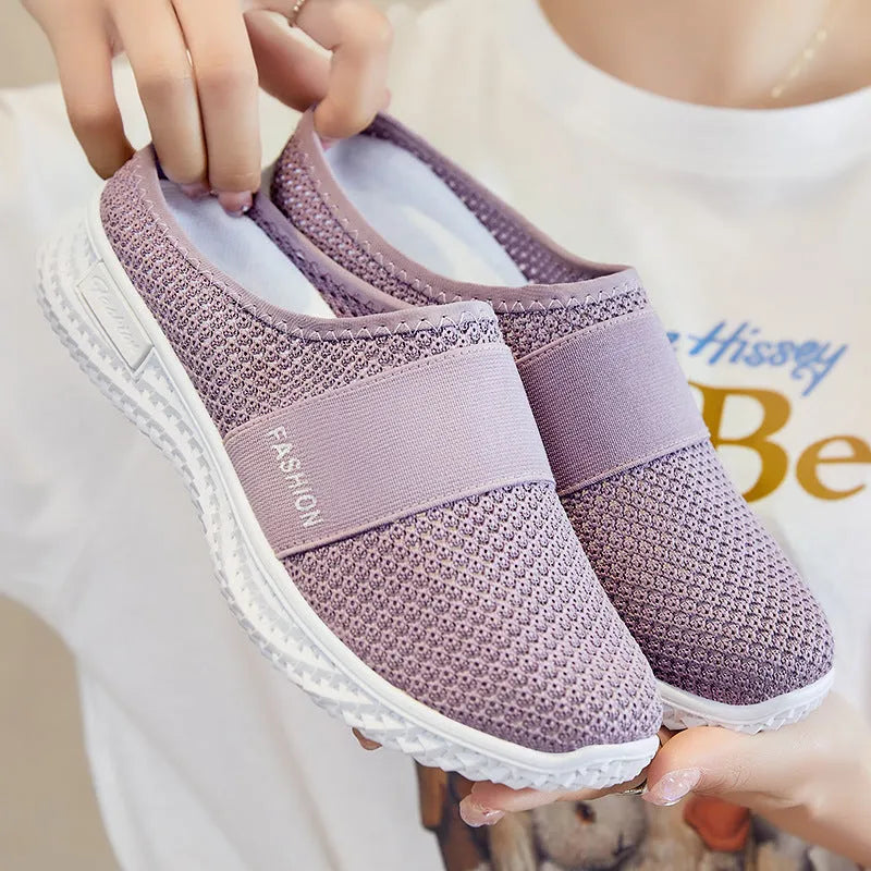 Women's breathable mesh casual shoes with hollow-out design and flat heel in round toe style.