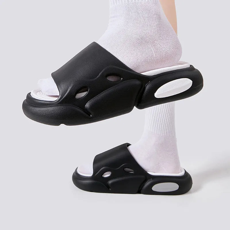 Two-colour thick-soled EVA slippers for couples on a floor, showing pink and purple or black and white colour options.