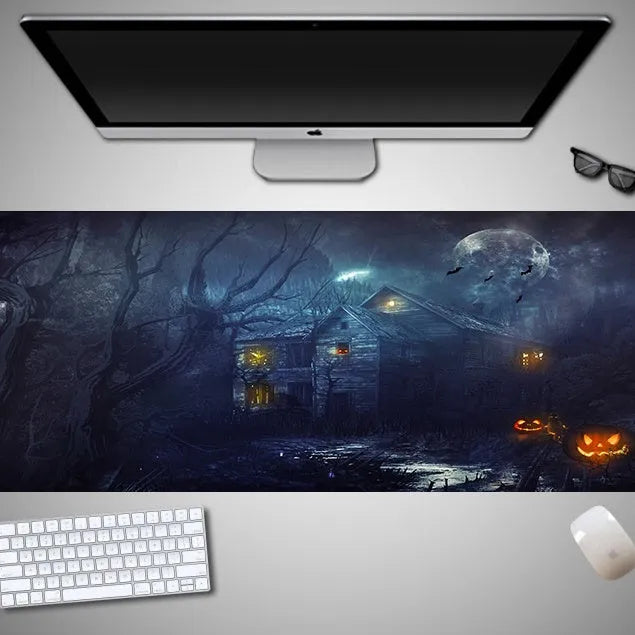Oversized Halloween-themed computer mouse pad with non-slip rubber cloth base on a desk