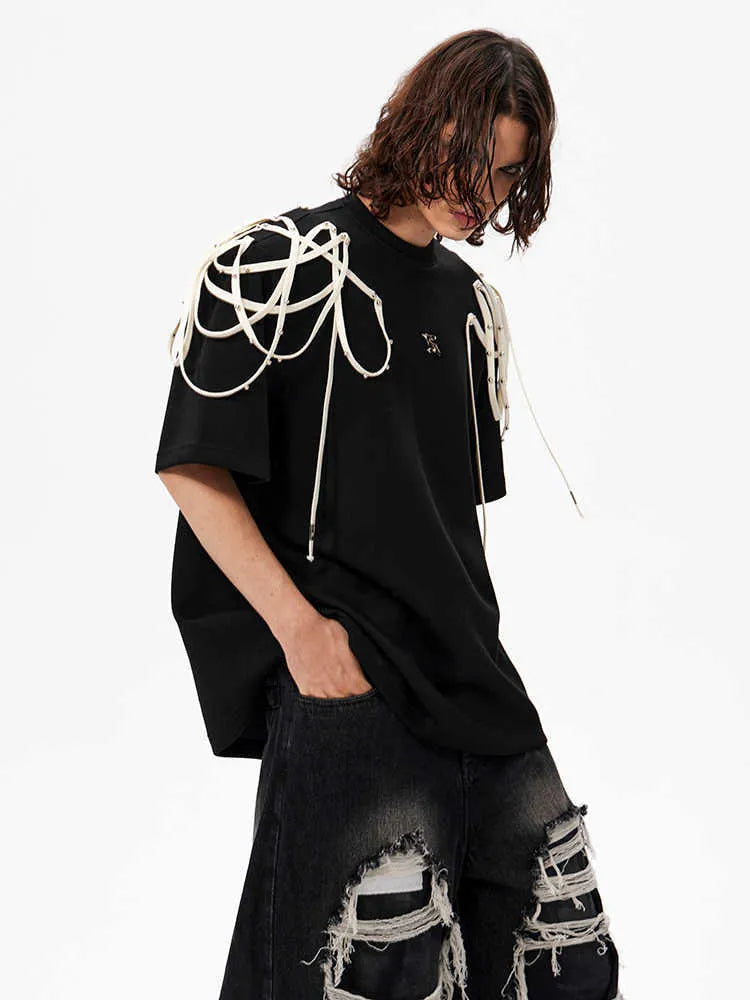 Black loose fit T-shirt with padded shoulders and decorative rivet ribbon detail on a short sleeve.