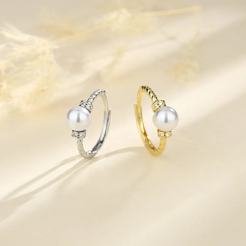 Adjustable antique twist ring with a pearl inlay, shown in gold and silver copper finish.