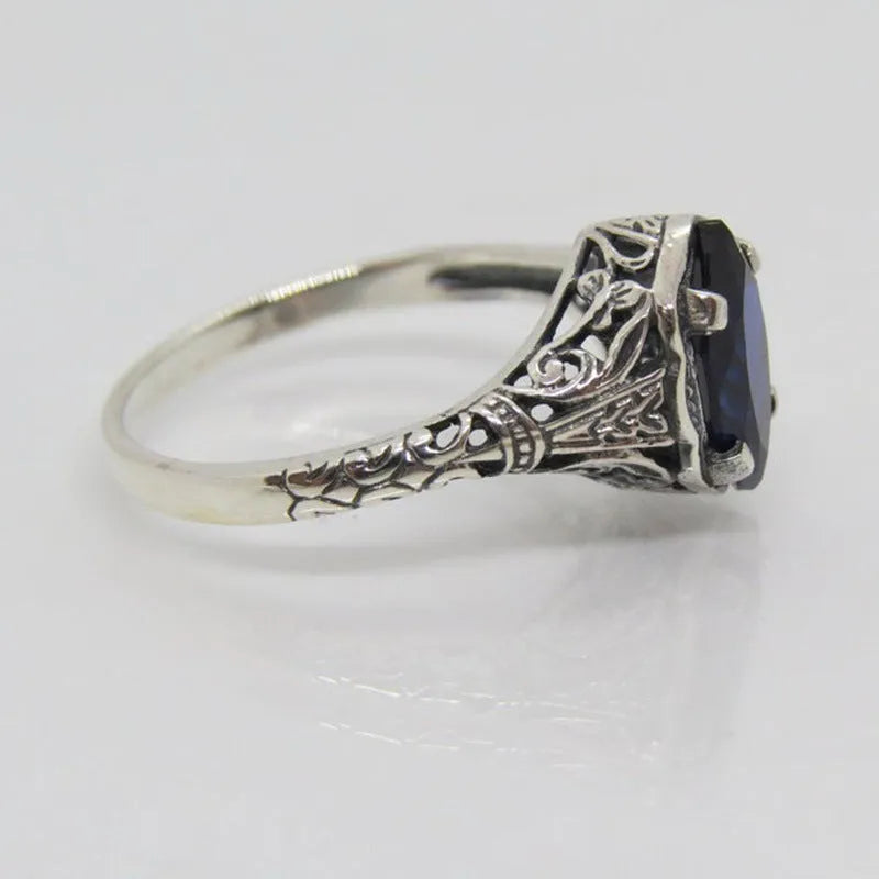 Women's silver geometric hollow ring showing alloy construction and detailed pattern