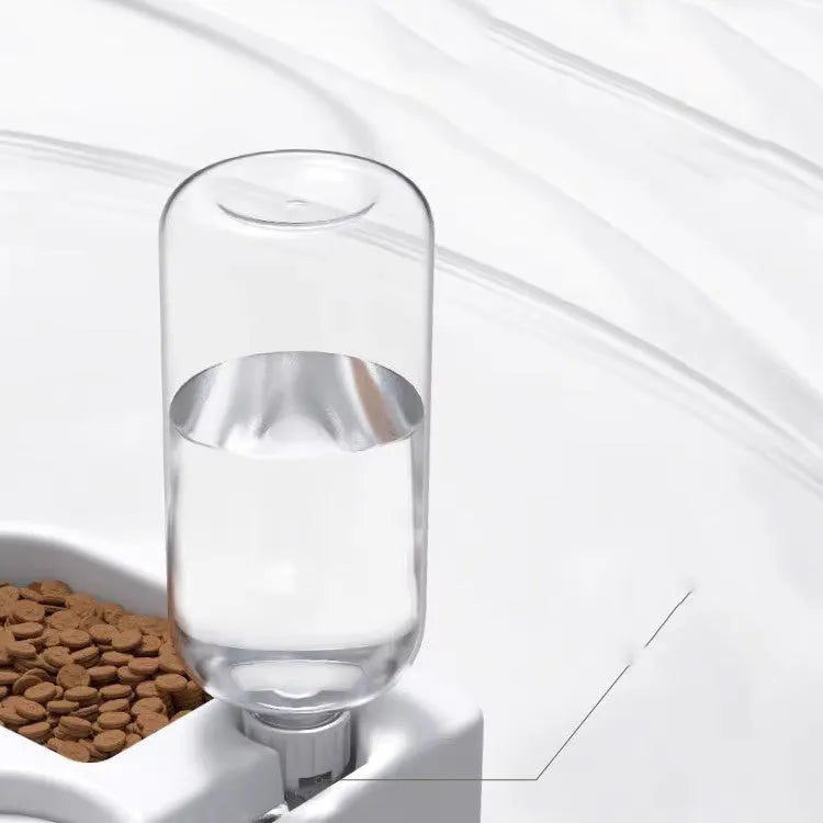 White automatic pet water fountain with stainless steel top on a floor.
