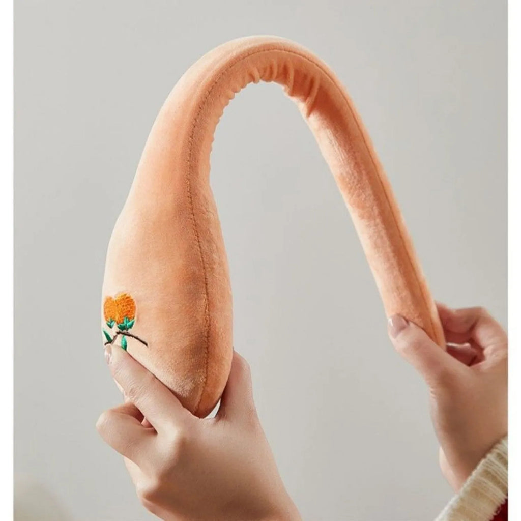 48 cm long persimmon coloured percussion massage stick with meridian flap design in a zipper case.