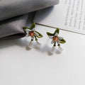 Women's alloy flower earrings set showing sterling silver needle flower studs and matching flower ear clip pair