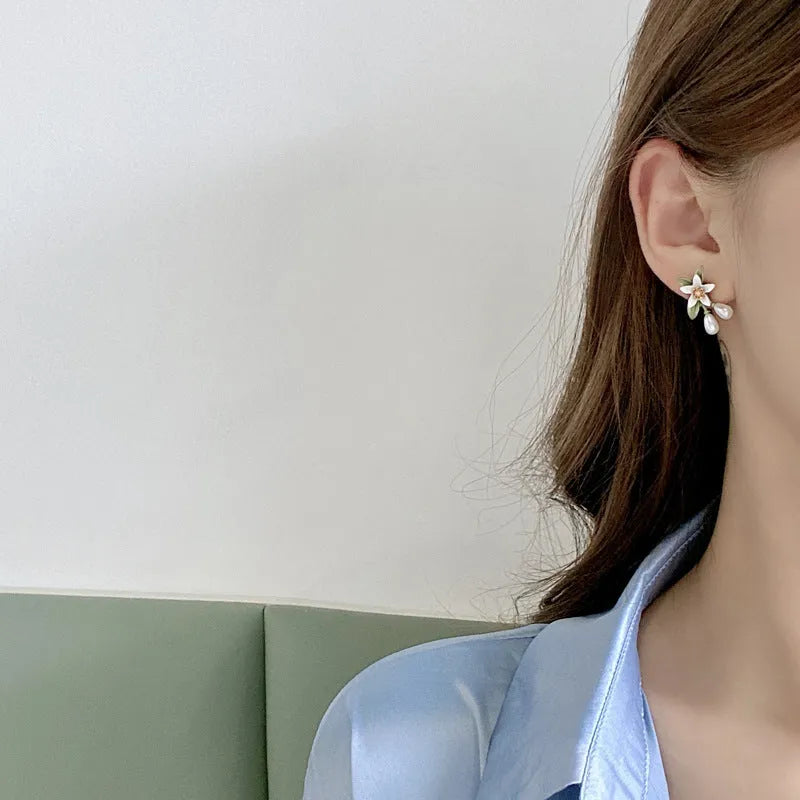 Women's alloy flower earrings set showing sterling silver needle flower studs and matching flower ear clip pair